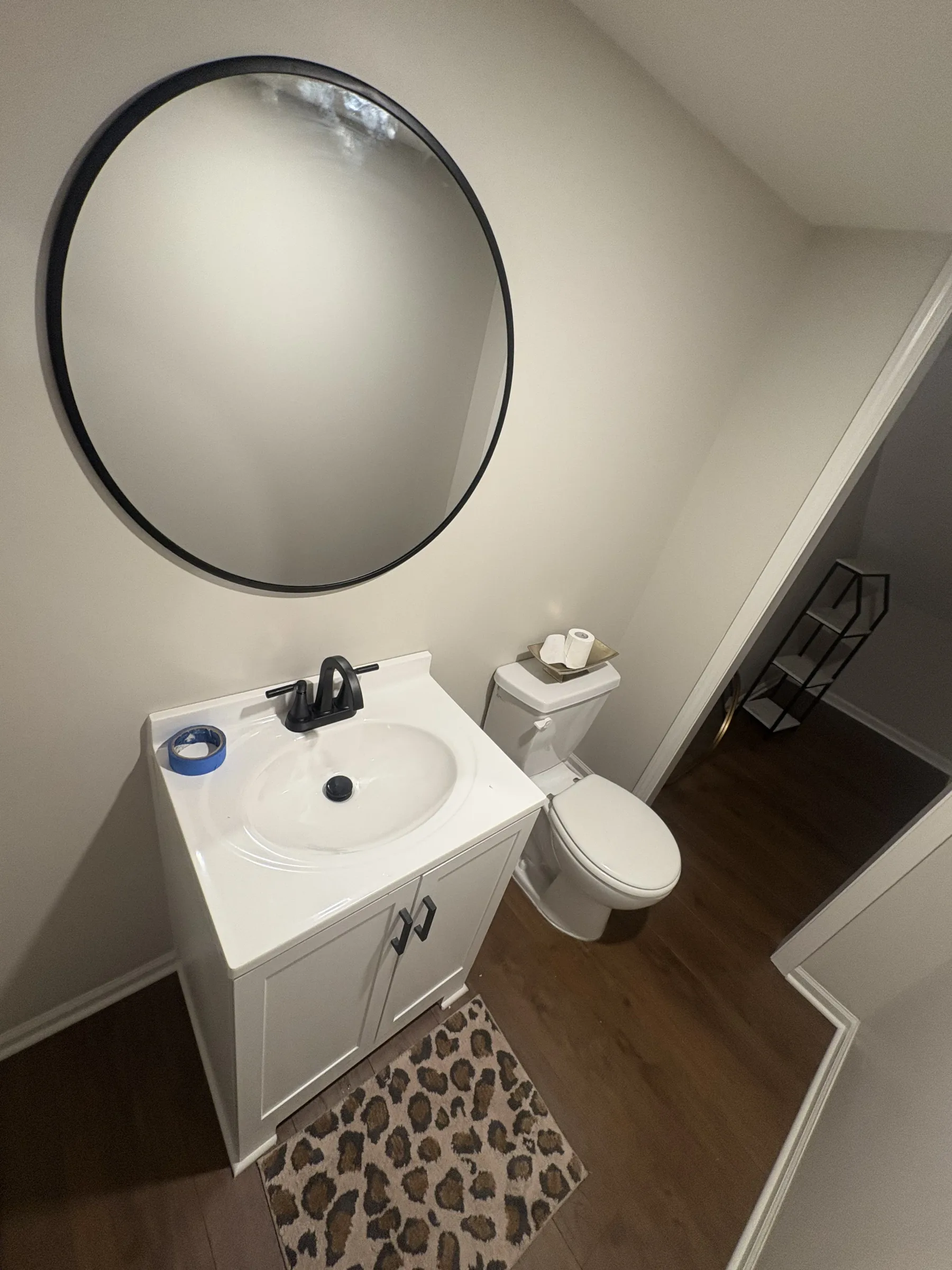 bathroom, sink, toilet, mirror, rug, wood floor